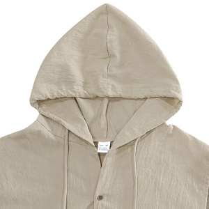 Detail of linen blend hooded shirt collar with size M tag and natural fabric texture