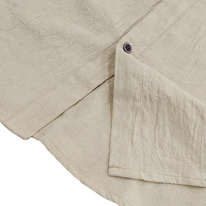 Close-up of natural linen fabric texture with neat stitching and a textured black button