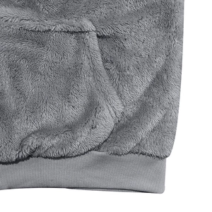 Detail view of plush grey fleece fabric with large pocket and elastic ribbed hemline