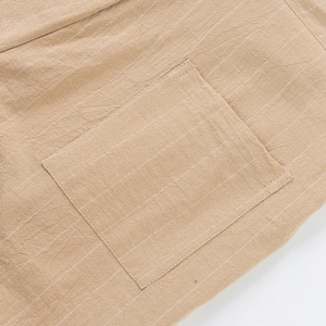 Detail view of khaki striped linen fabric showing a high-quality square patch pocket