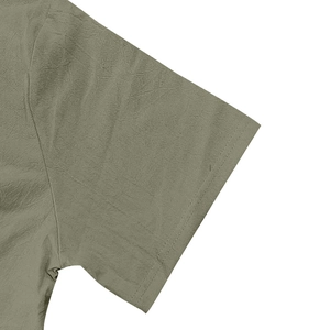 Detailed macro view showing olive green linen fabric texture and double-stitched sleeve cuff