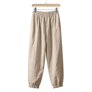Detail view of oatmeal linen joggers featuring elastic waist and tapered cuffs for comfort