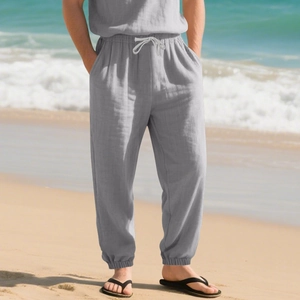 Detail of grey linen trousers with drawstring elastic waistband and ribbed ankle cuffs