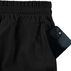 Detail view of men's corduroy shorts featuring elastic waistband and deep functional pockets