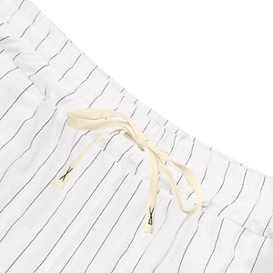 Detail of men's striped linen shorts with elastic waist and cream drawstring