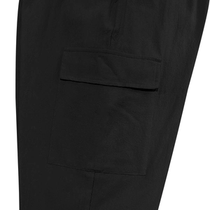 Close-up of matte black cargo pocket with flap detail on linen blend workwear pants