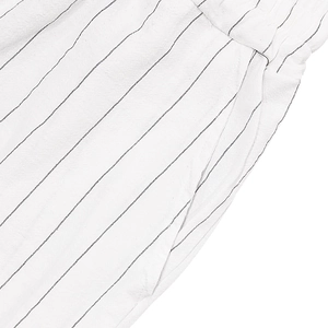Close-up of linen blend striped fabric showing side pocket detail and natural texture