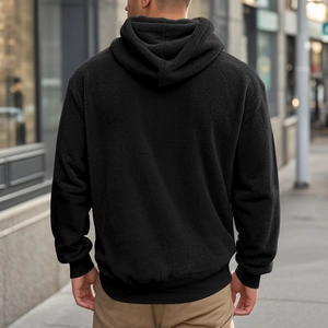 Rear view of man in black fleece hoodie featuring warm Sherpa texture in urban setting