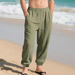 Detail of olive green linen pants featuring elastic drawstring waist and side pockets