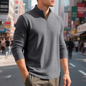 Close-up of men's grey waffle knit quarter-zip pullover with metal zipper and stand collar