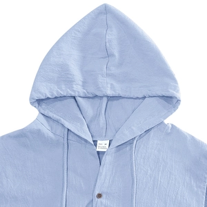 Detail of light blue linen blend hoodie showing button closure and fabric texture