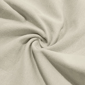 Macro texture of beige linen fabric showing breathable weave and natural drape quality