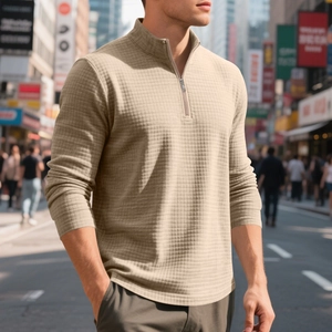 Detail of men's beige waffle knit sweatshirt with quarter-zip collar in street setting