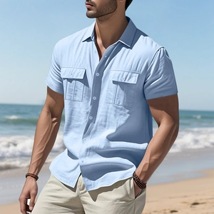 Close-up of light blue linen shirt featuring classic collar and double chest pockets