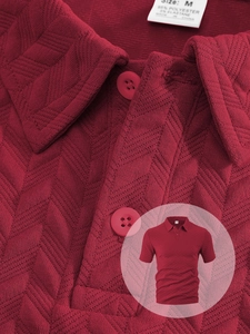 Detail of dark red men's Polo shirt featuring jacquard knit texture and button placket