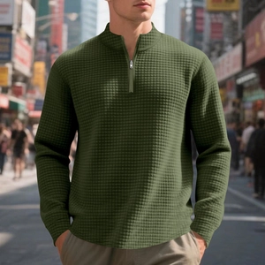 Detail of waffle-knit fabric and 1/4 zipper on olive green men's stand-collar sweatshirt