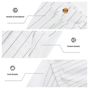 Detail view of white striped linen pants showing waistband, pocket and hem features