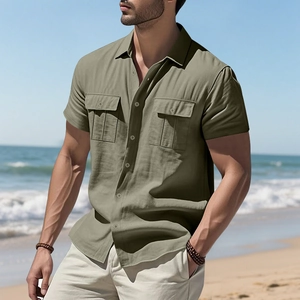 Detail of army green linen shirt with dual chest pockets and casual texture in a beach setting