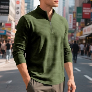 Detail of army green waffle knit texture and quarter-zip collar on men's pullover