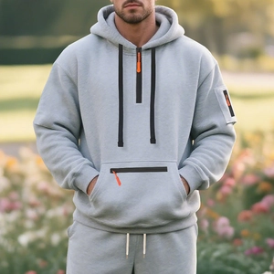 Detail of grey fleece hoodie with half-zip closure and orange puller for men