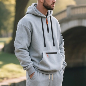 Detail of grey men's quarter-zip fleece hoodie with black stripes and tactical arm pocket