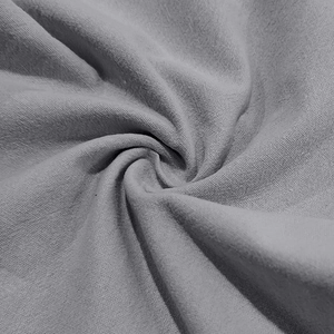 Macro shot of grey linen fabric texture showing breathable weave and detailed folds
