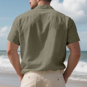 Back view of a men's short-sleeved linen shirt in olive green for beach vacations
