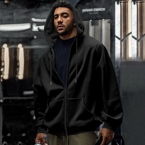 Men's black waterproof hoodie with zipper and ribbed cuffs shown in gym setting