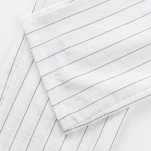 Macro detail of breathable striped linen fabric with fine black vertical lines