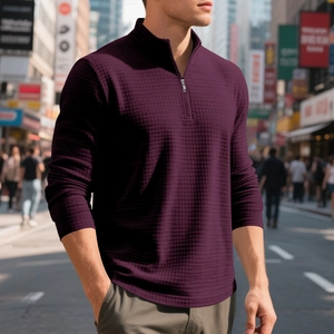 Detail of deep purple waffle knit sweatshirt featuring a quarter-zip stand collar and texture