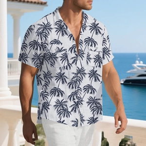 Detail of white beach shirt with blue palm trees, linen texture, and dual chest pockets