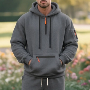 Detail of grey winter fleece hoodie featuring an orange zipper pull and cargo chest pocket