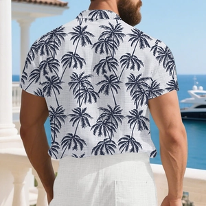 Detail of tropical palm tree print on a white short-sleeve linen shirt for men
