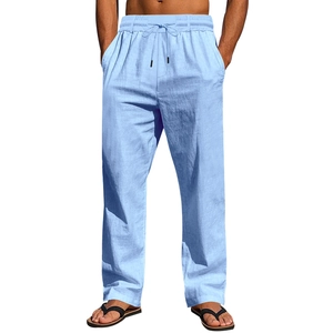 Detailed view of light blue linen trousers showing elastic waistband and drawstring cords