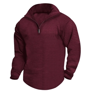 Detailed view of burgundy waffle texture knit on men's quarter-zip pullover sweatshirt
