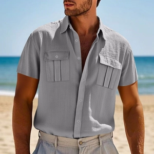 Close-up of grey men's linen short sleeve shirt with chest pockets at the beach