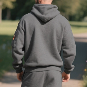 Rear view of thick fleece hoodie with sleeve patch pocket and matching gray joggers