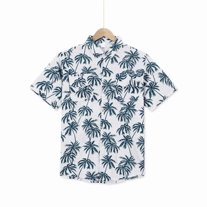 Detail of tropical coconut tree print on men's relaxed short-sleeve Hawaiian resort shirt