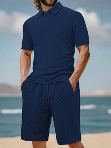Close-up of navy blue men's polo set featuring premium textured herringbone fabric
