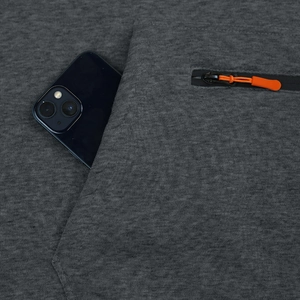 Close-up of deep gray fleece hoodie with orange zipper pocket and phone storage detail