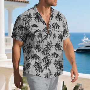 Detail of grey short sleeve shirt with black palm tree prints and front chest pockets