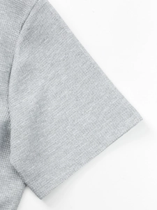 Detailed macro view showing grey waffle knit texture and stitching on men shirt sleeve
