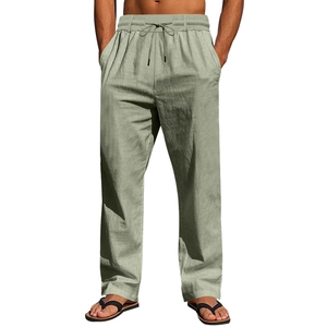 Detailed close-up of men's loose linen beach trousers featuring drawstring elastic waist