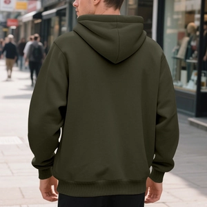 Rear view of an olive green heavyweight hoodie featuring ribbed cuffs and hem on city street