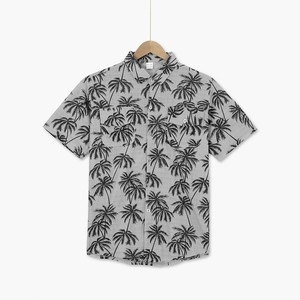 Close-up of tropical palm tree print and button pocket on men's short sleeve resort shirt