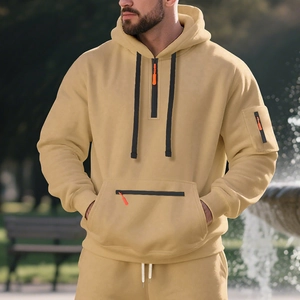 Detail view of khaki fleece hoodie with orange zipper pull and tactical sleeve pocket