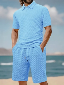 Close-up of light blue jacquard knit polo shirt and shorts set with textured pattern