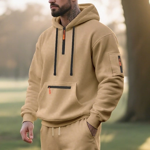 Detail of khaki fleece hoodie featuring orange zipper pulls and half-zip collar design