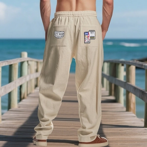 Rear view of loose linen pants for men with graffiti patch pocket and drawstring waist