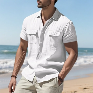 Detailed close-up of white linen shirt showing chest pockets and classic collar design